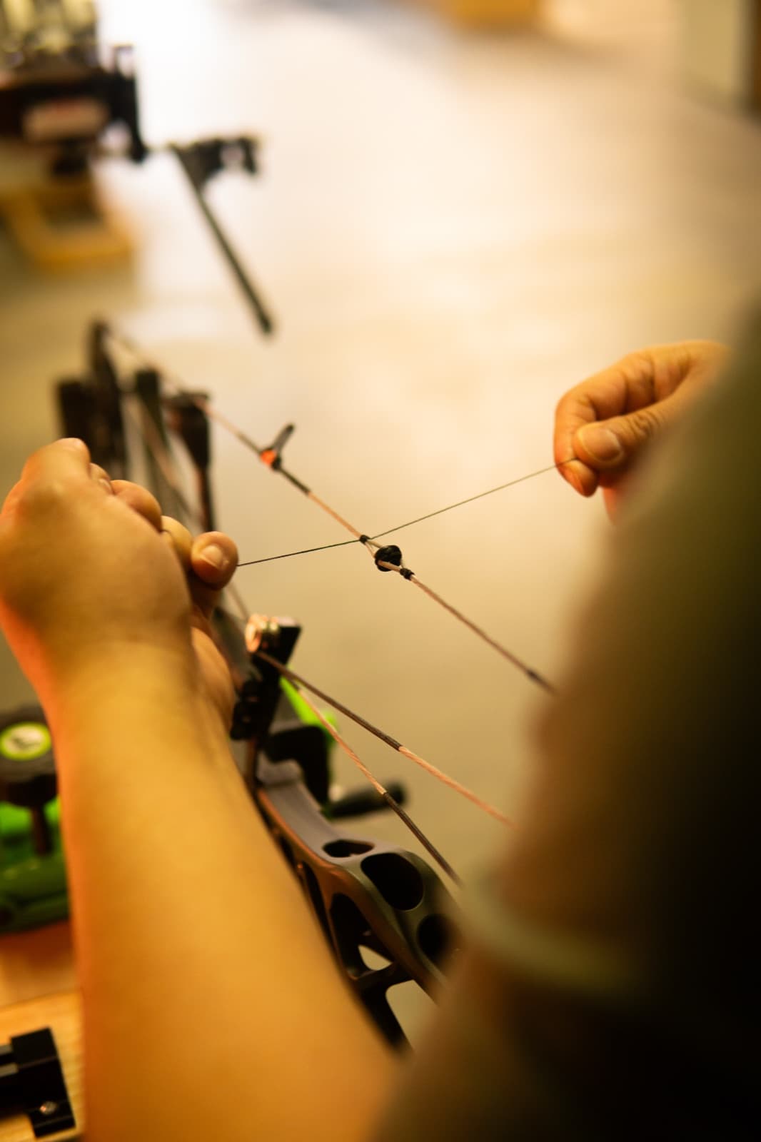 Hands setting a D-loop on the string